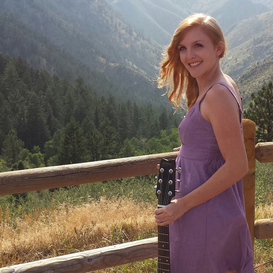 Photo of Sarah Aukerman outdoors with guitar
